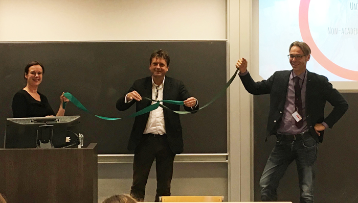 Gert-Jan Burgers, director of CLUE+, ties a ceremonial knot to symbolize the center's aim to connect various disciplines and communities.