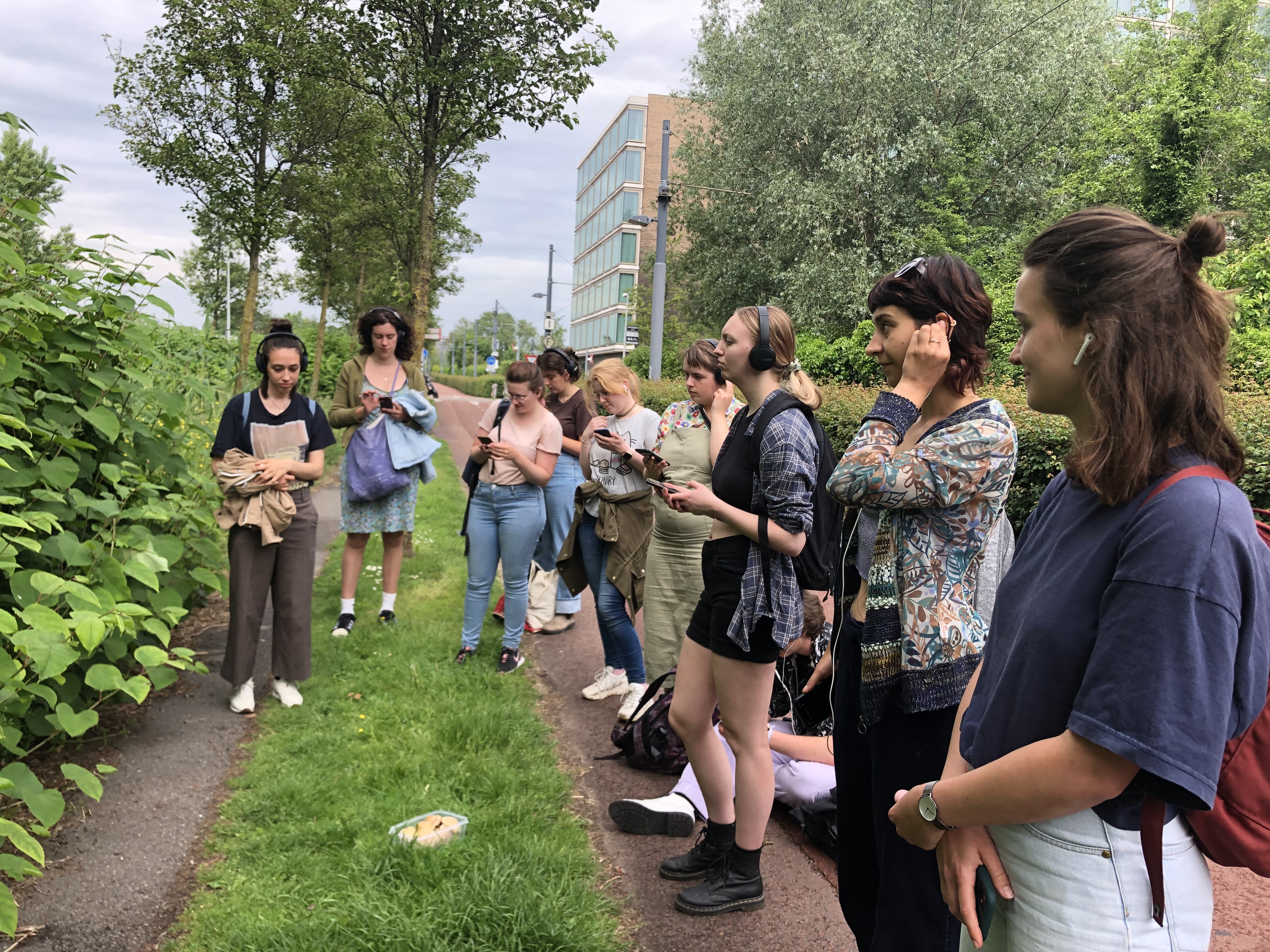 Students listening to a podcast tour